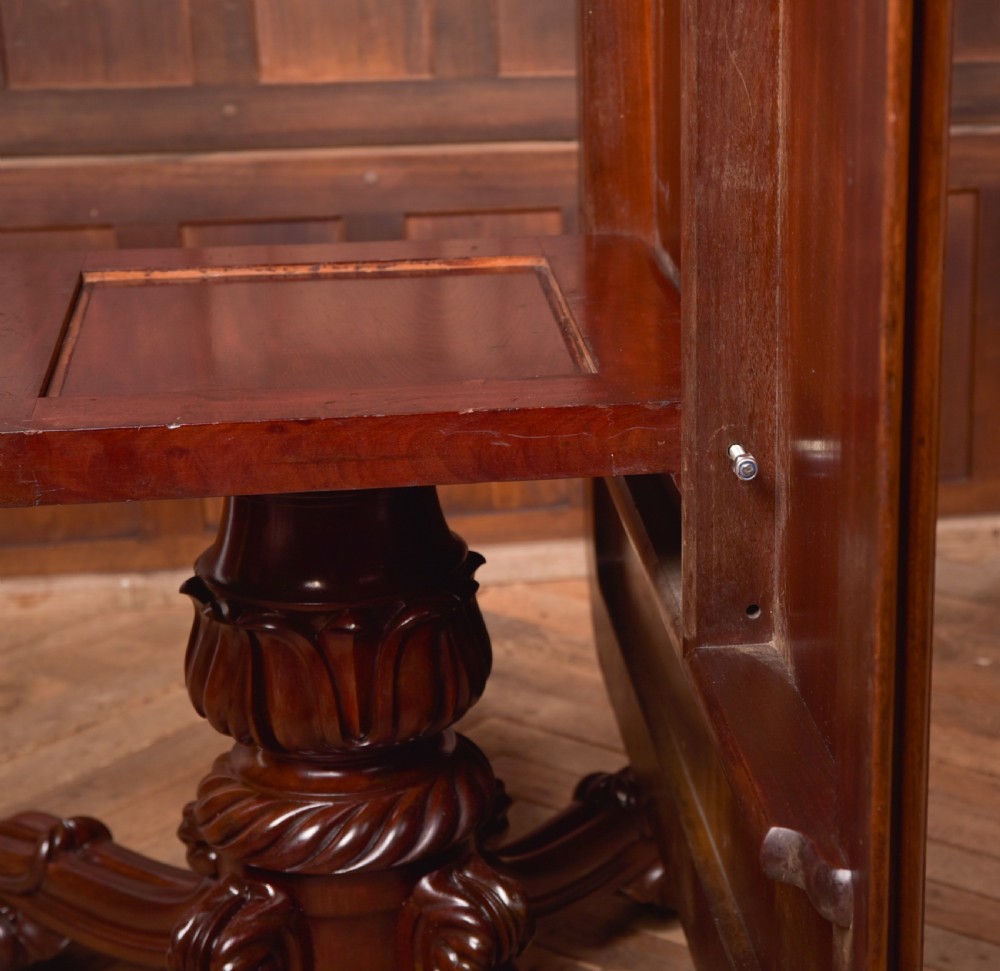 A Victorian mahogany tilt-top table featuring a polished rectangular top with rounded corners set upon a carved pedestal stem with quadruped scrolled legs. View XIV