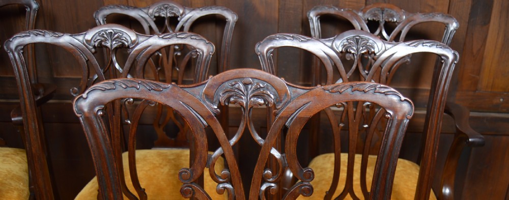A set of eight dark mahogany Chippendale style dining chairs featuring carved pierced splats, gold velvet upholstery, and cabriole legs with ball-and-claw feet. View III