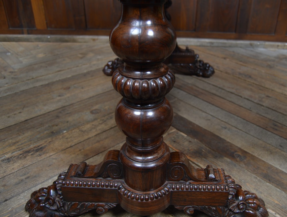 A William IV dark rosewood library side table featuring two frieze drawers with wooden knobs, beaded edge details, turned column supports, and carved claw feet. View XII