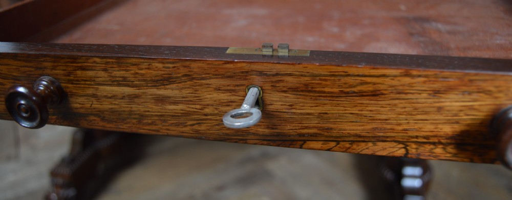 A William IV dark rosewood library side table featuring two frieze drawers with wooden knobs, beaded edge details, turned column supports, and carved claw feet. View XIX