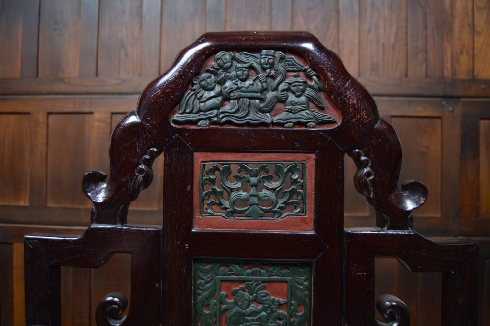 A pair of dark hardwood Chinese armchairs featuring intricate carved back panels, polychrome accents, and pale marble inset seats. View XII