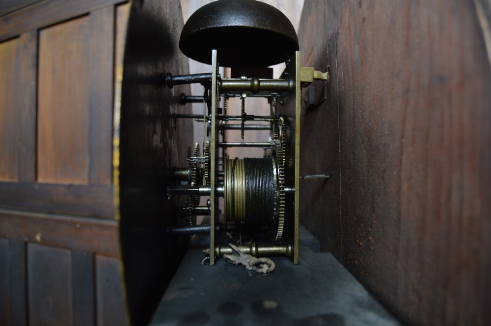 A nineteenth-century Scottish drum head longcase clock crafted from flame mahogany with an ornate circular brass dial. View XV