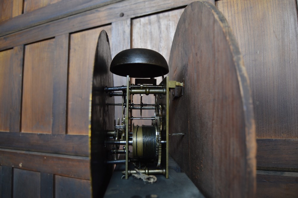 A nineteenth-century Scottish drum head longcase clock crafted from flame mahogany with an ornate circular brass dial. View XVI