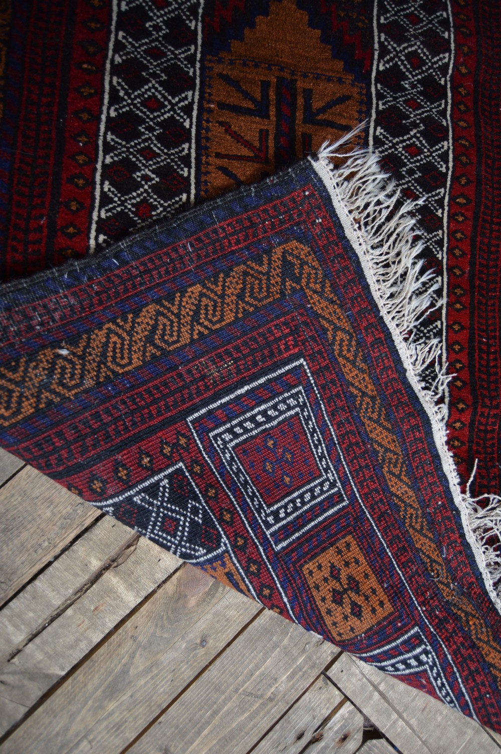 A hand-woven Belouch wool prayer rug featuring a central ochre mihrab motif surrounded by dark red and geometric patterned borders. View VIII