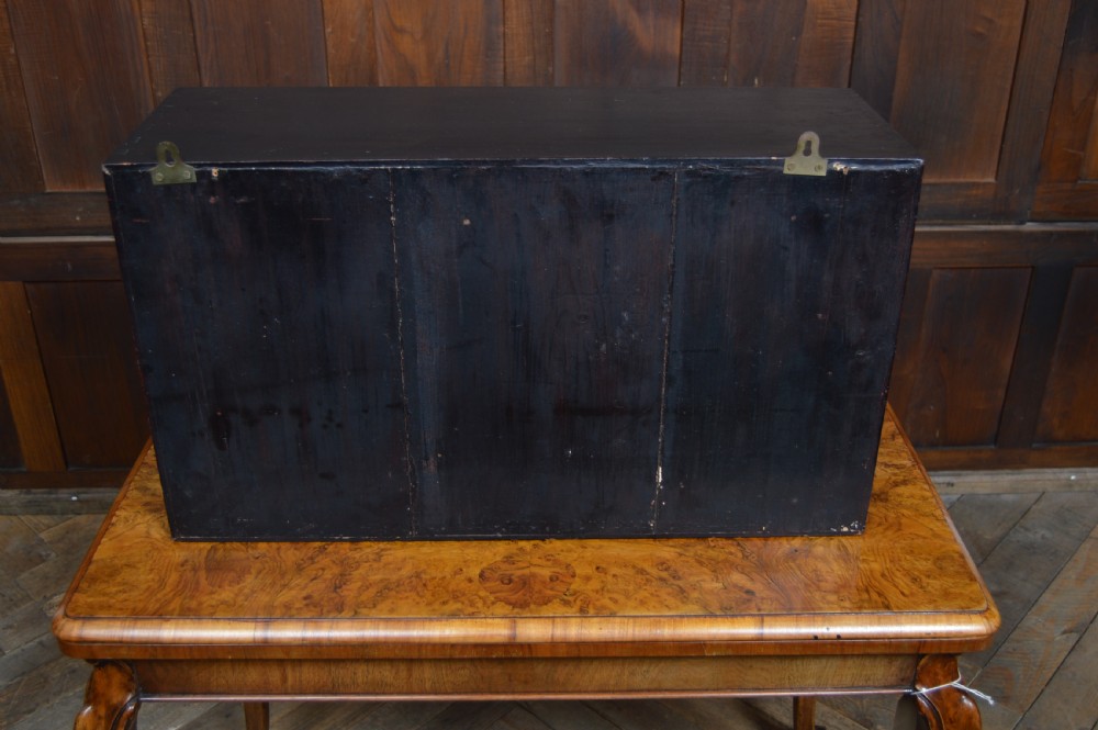 A detailed three-masted clipper ship model with fine thread rigging set against a painted sea and sky inside a black glazed display case. View VIII