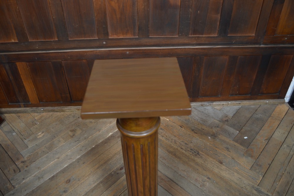 A Victorian mahogany pedestal stand featuring a central fluted column on a square base topped with a square flat platform. View VII