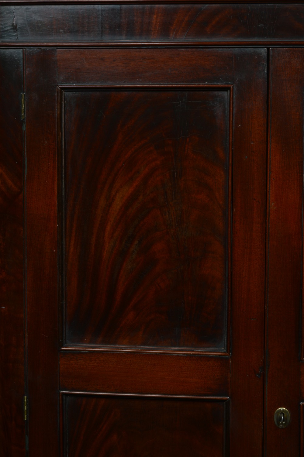 A tall freestanding Georgian corner cabinet made from mahogany featuring flame grain wood door panels and a moulded top cornice. View VIII