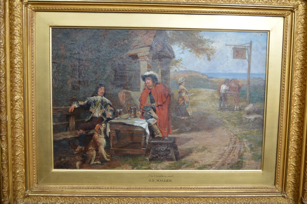 An antique oil painting depicting 17th-century cavaliers resting outside an inn, presented in an ornate gold gilt frame with an artist plaque. View IV