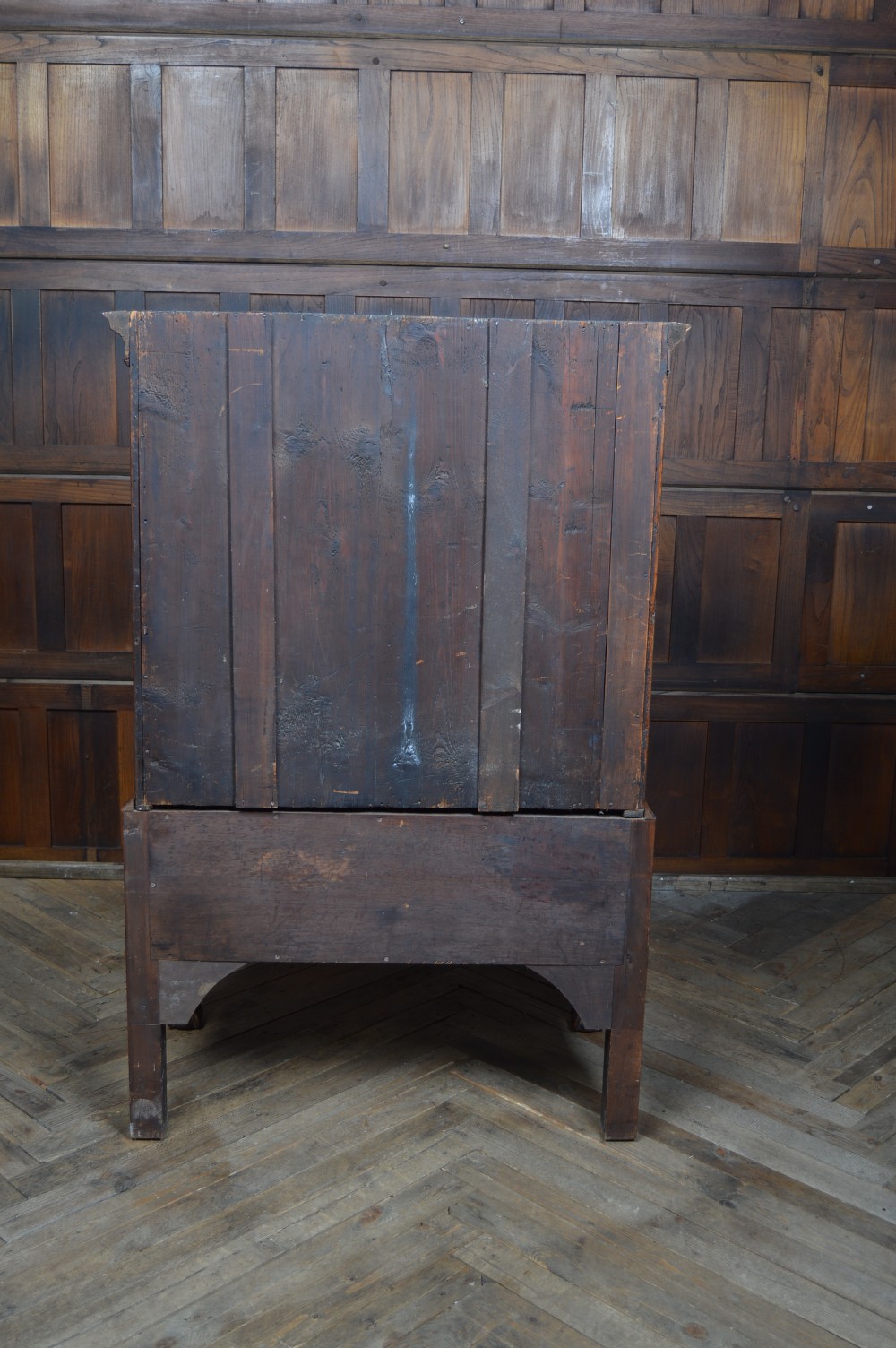 A Georgian walnut chest on stand with layered drawers, decorative brass drop handles, and carved cabriole legs. View XVII