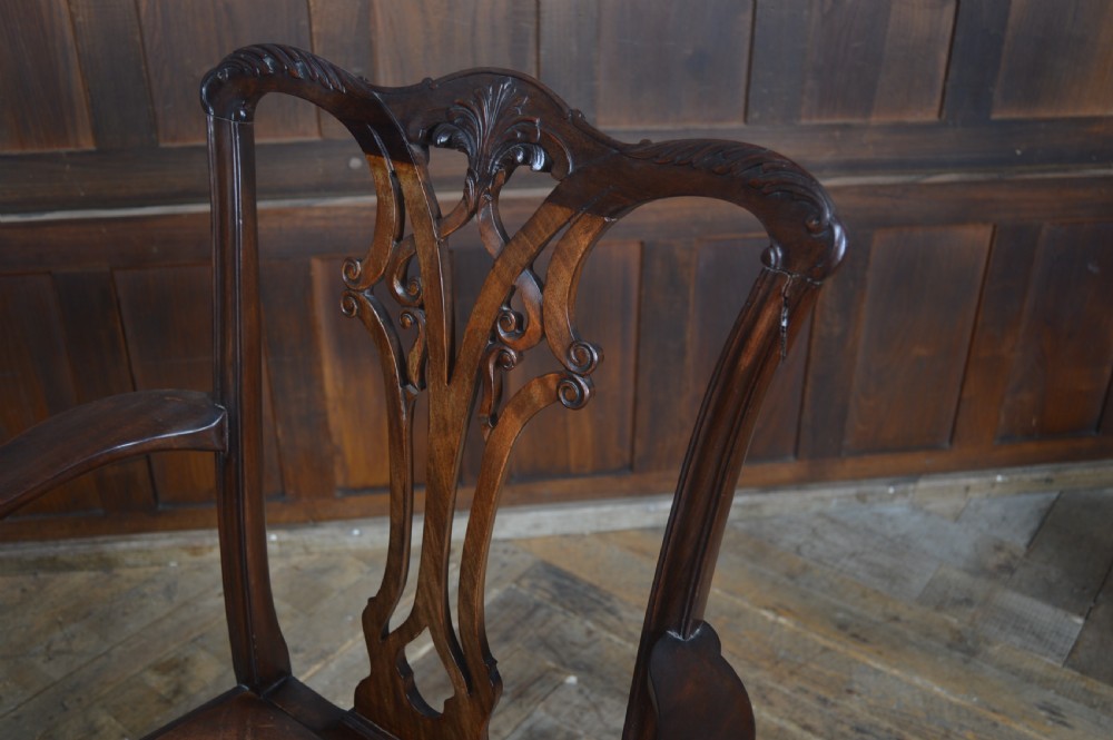 A set of eight dark mahogany Edwardian Chippendale style dining chairs featuring pierced back splats, leather seats, and cabriole legs with ball and claw feet. View VI