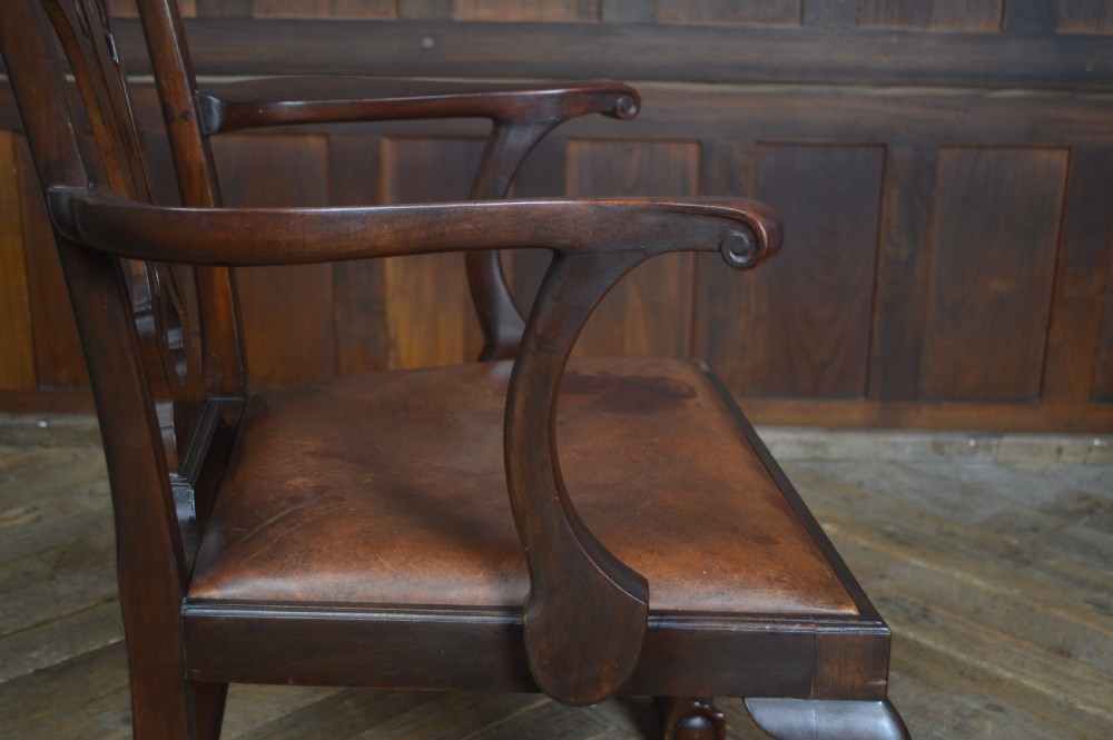 A set of eight dark mahogany Edwardian Chippendale style dining chairs featuring pierced back splats, leather seats, and cabriole legs with ball and claw feet. View VII