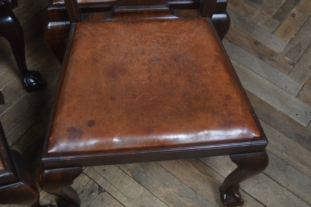 A set of eight dark mahogany Edwardian Chippendale style dining chairs featuring pierced back splats, leather seats, and cabriole legs with ball and claw feet. View XI