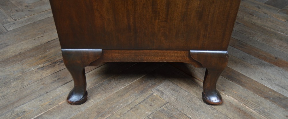 A mahogany chest of drawers featuring flame mahogany drawer fronts, two short over two long drawers, brass handles, and cabriole legs. View XIII
