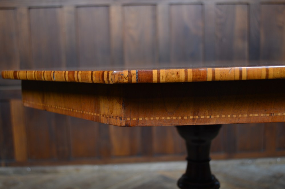 A Victorian octagonal Sorrento side table featuring intricate star marquetry, geometric inlays, a turned pedestal support, and a tripod base. View V