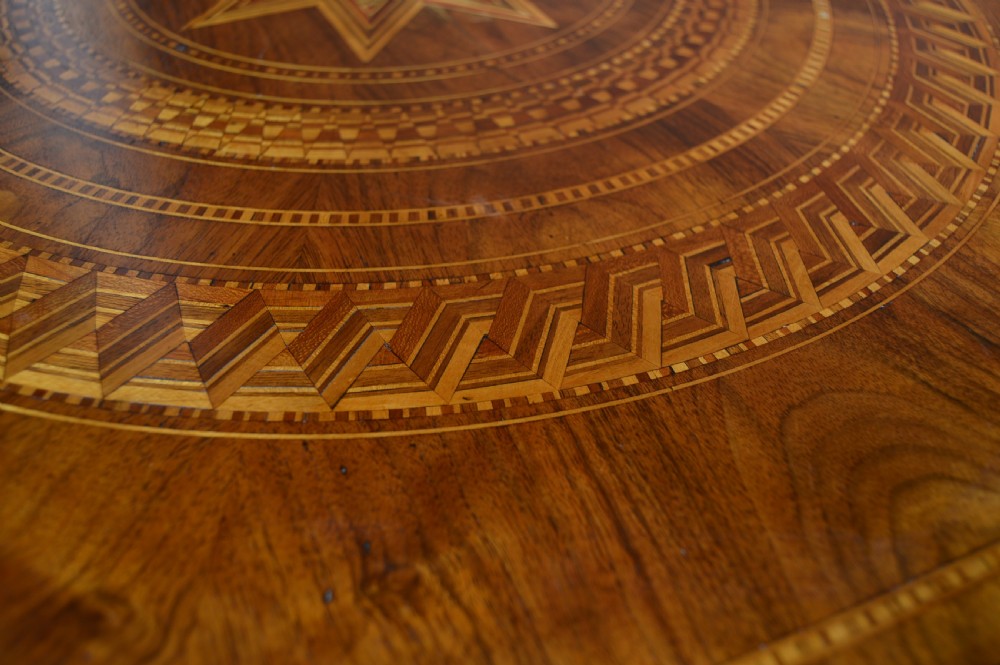 A Victorian octagonal Sorrento side table featuring intricate star marquetry, geometric inlays, a turned pedestal support, and a tripod base. View VII