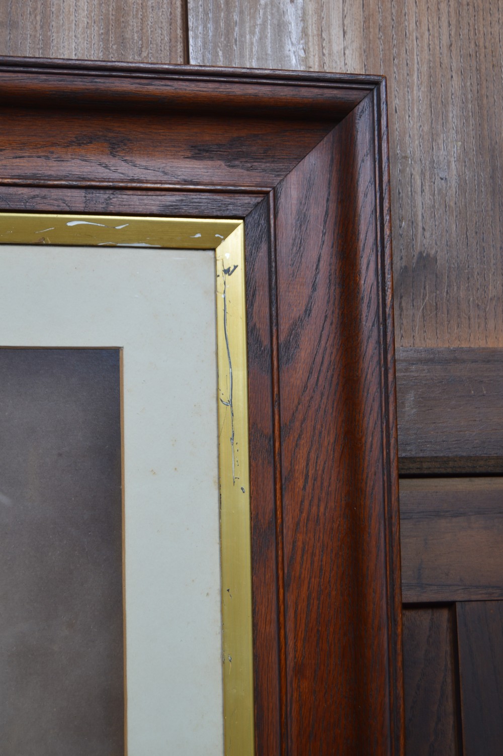 A monochrome photographic portrait of a male military officer in uniform, displayed within a cream mount, gilt slip, and dark moulded oak frame. View VI