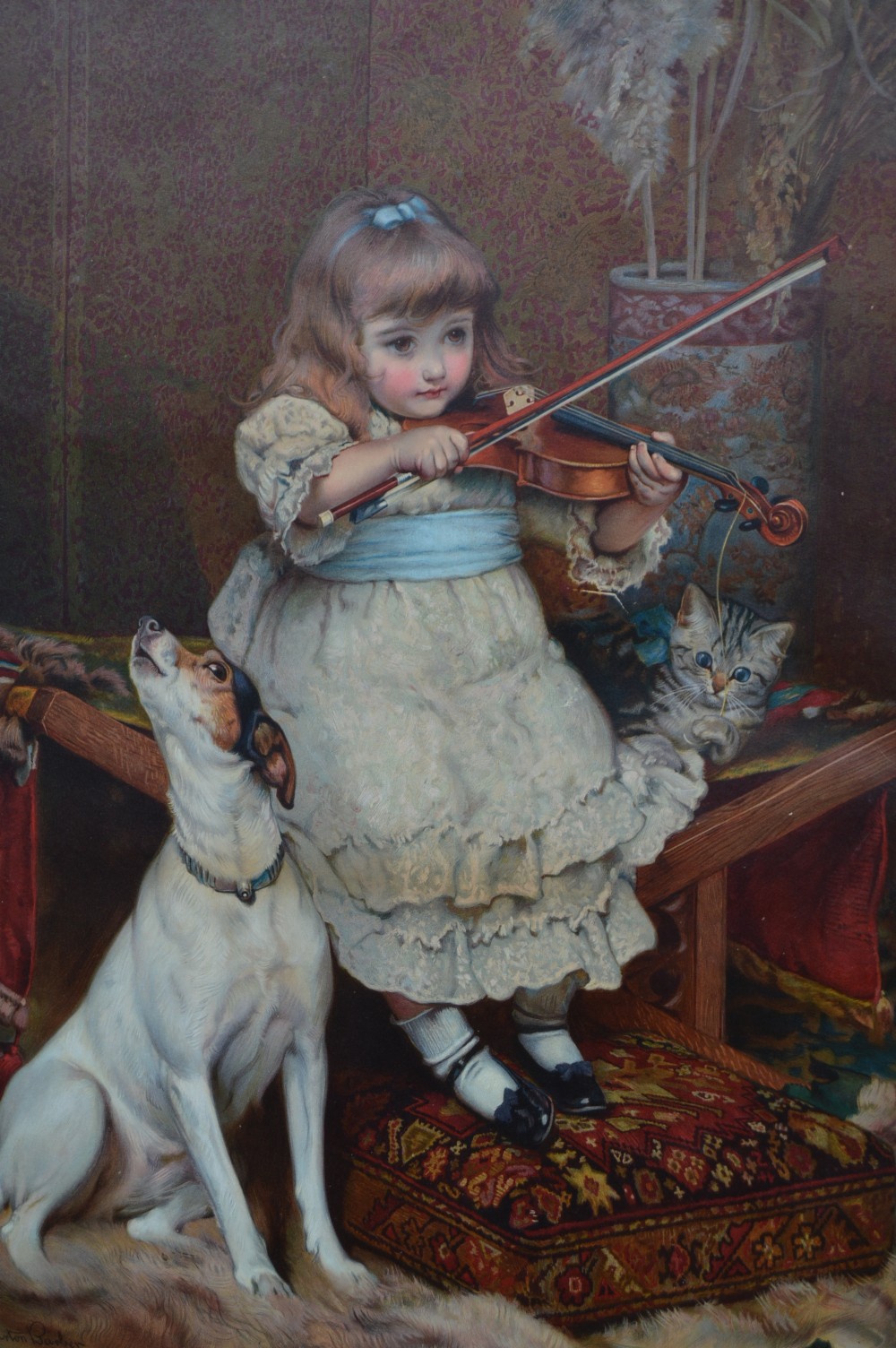 A framed Victorian chromolithograph after Charles Burton Barber depicting a young girl playing a violin to a terrier and kitten, set within a carved dark wood frame. View III