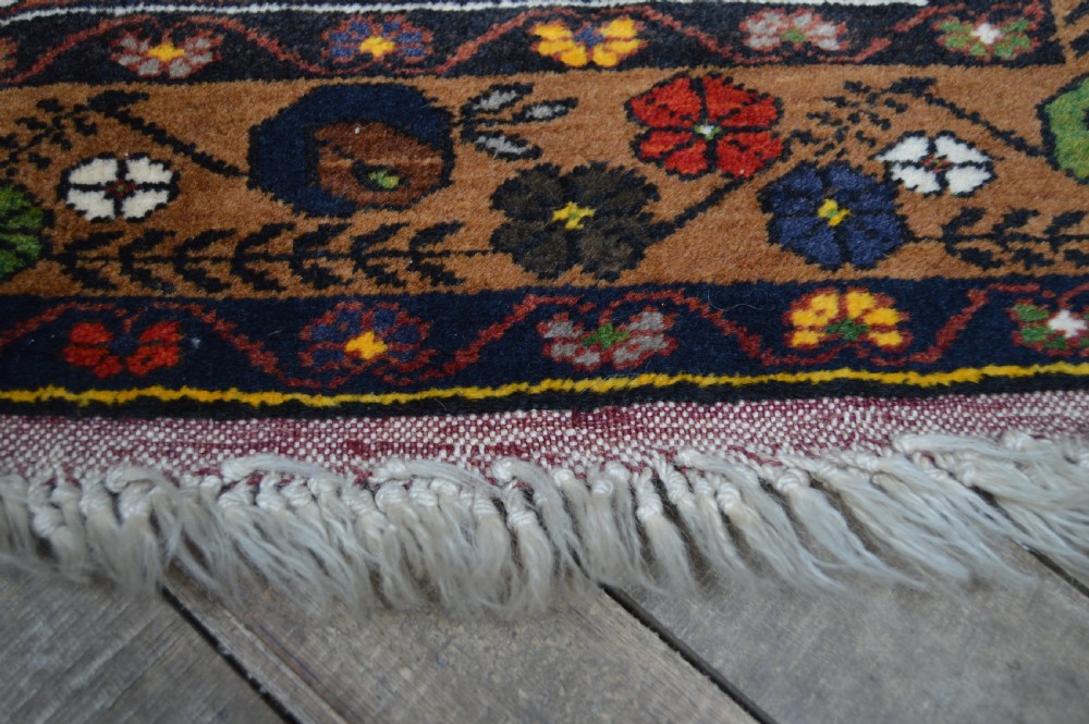 A long hand-knotted Turkish rug runner featuring a central light grey and blue geometric medallion on a terracotta red field, framed by dark navy spandrels and a multi-band decorative border. View VIII