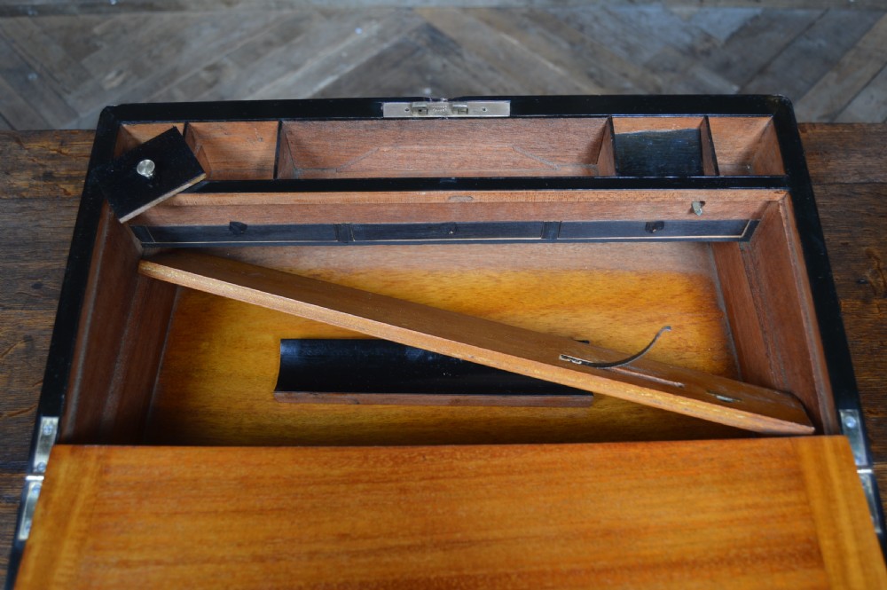 A closed rectangular Victorian burr walnut writing slope featuring metal border trim, a keyhole escutcheon, and an engraved metal presentation plaque on top. View XVII