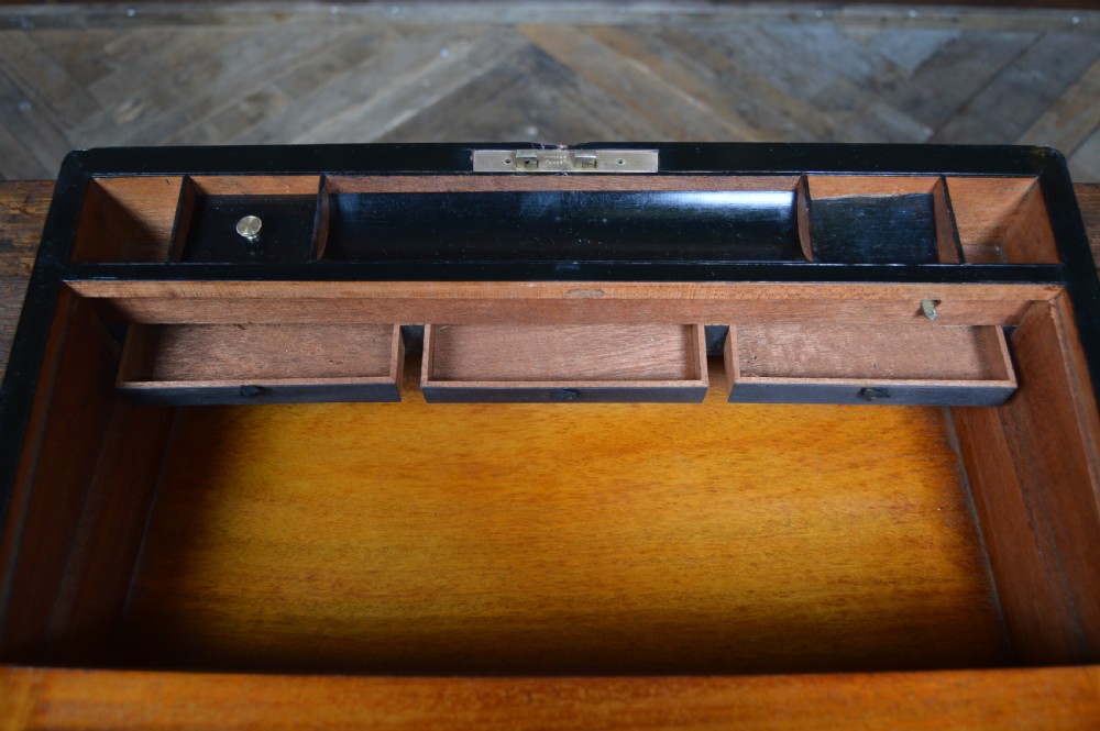 A closed rectangular Victorian burr walnut writing slope featuring metal border trim, a keyhole escutcheon, and an engraved metal presentation plaque on top. View XVIII