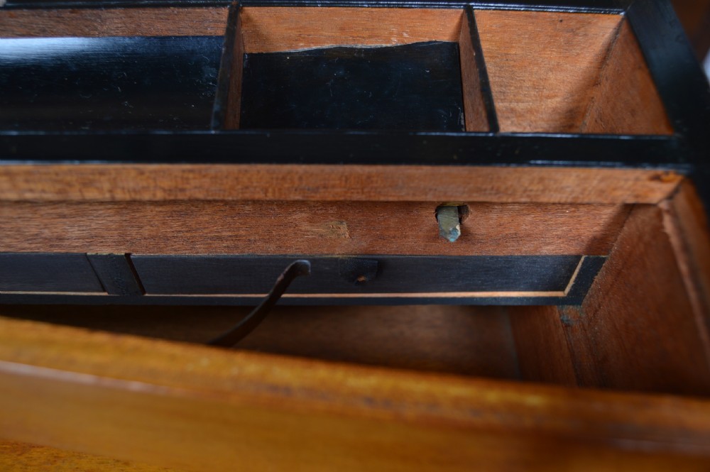 A closed rectangular Victorian burr walnut writing slope featuring metal border trim, a keyhole escutcheon, and an engraved metal presentation plaque on top. View XIX
