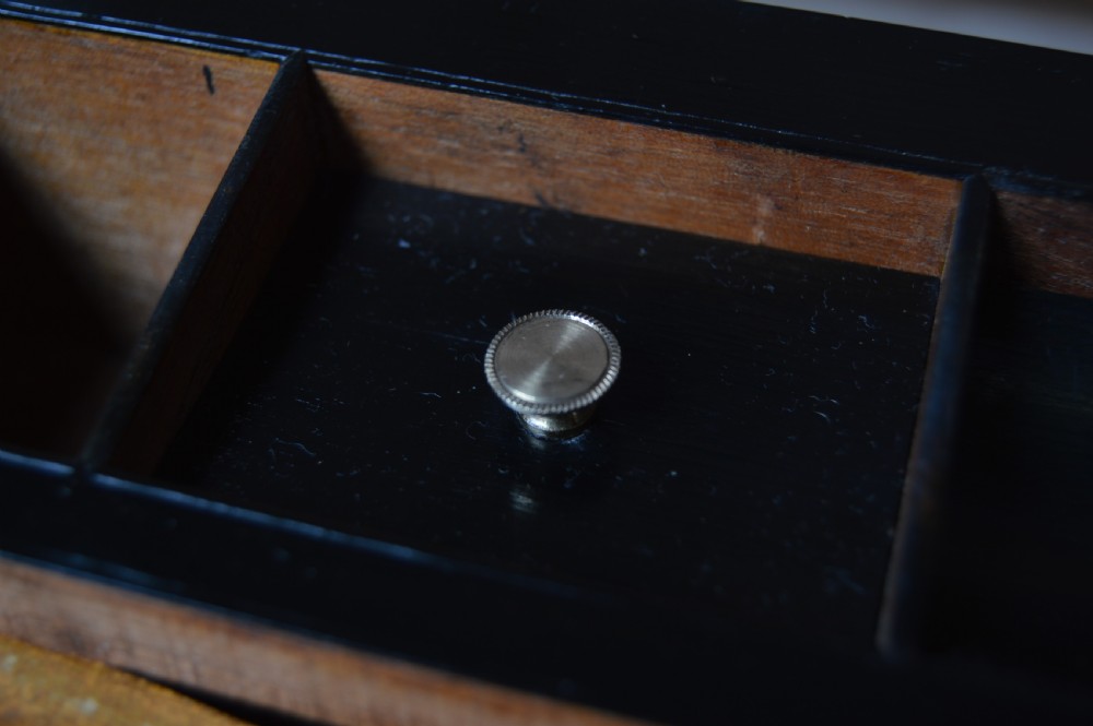 A closed rectangular Victorian burr walnut writing slope featuring metal border trim, a keyhole escutcheon, and an engraved metal presentation plaque on top. View XX