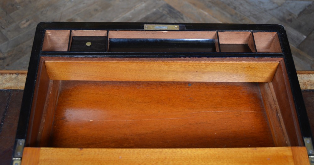 A closed Victorian burr walnut writing slope featuring brass corner straps, stringing inlay, and a brass keyhole escutcheon. View XI