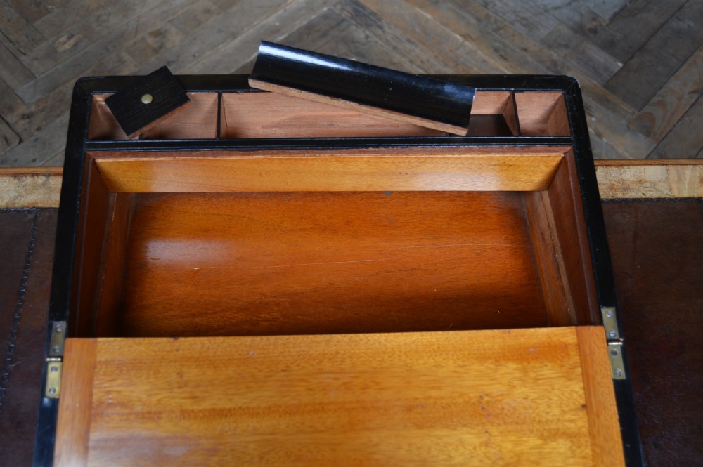 A closed Victorian burr walnut writing slope featuring brass corner straps, stringing inlay, and a brass keyhole escutcheon. View XII