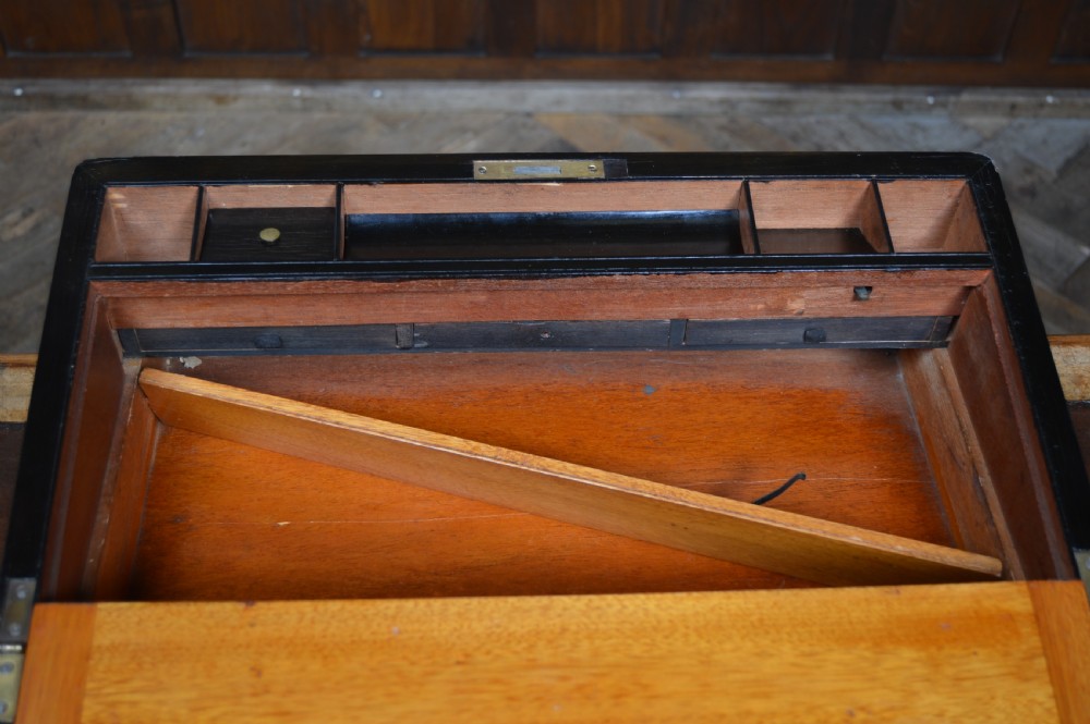 A closed Victorian burr walnut writing slope featuring brass corner straps, stringing inlay, and a brass keyhole escutcheon. View XIII