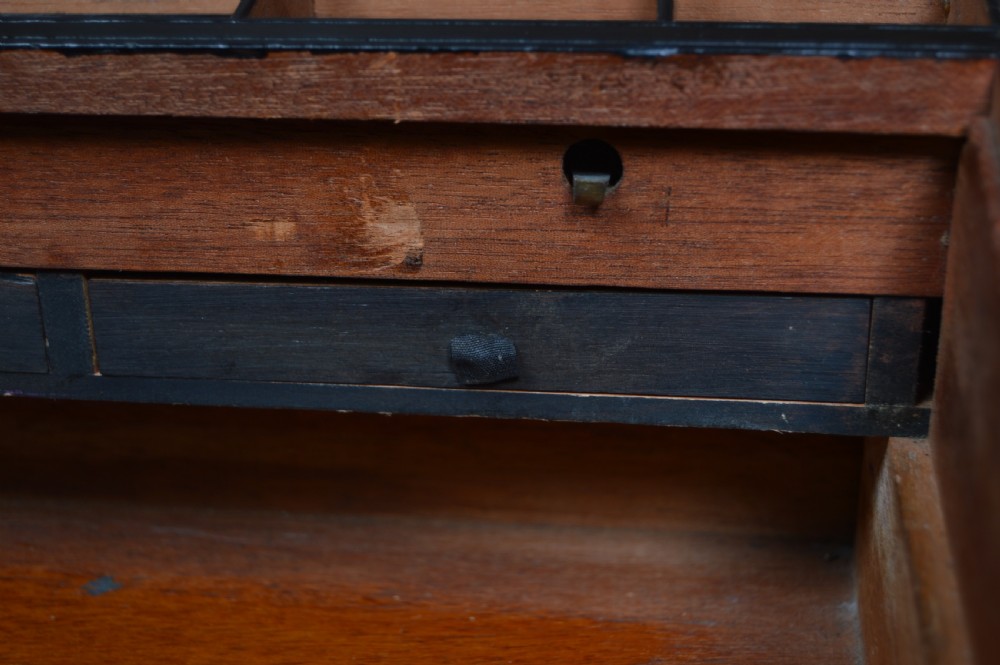 A closed Victorian burr walnut writing slope featuring brass corner straps, stringing inlay, and a brass keyhole escutcheon. View XIV