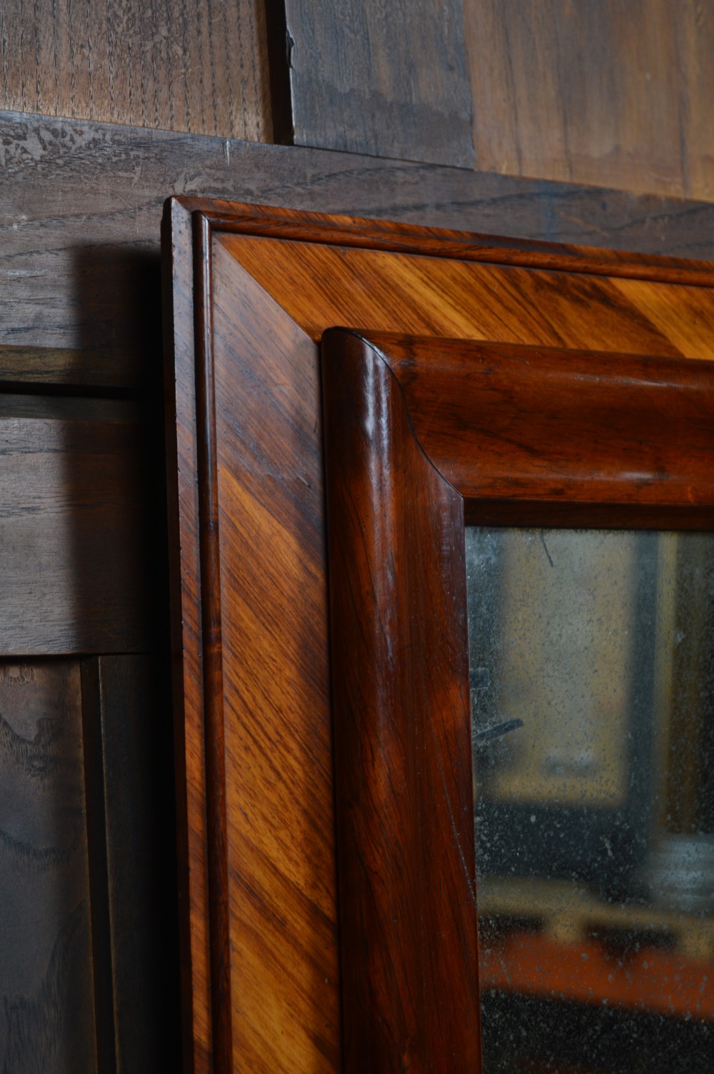A rectangular antique wall mirror featuring a rich rosewood and kingwood crossbanded timber frame with distressed mirror glass. View III