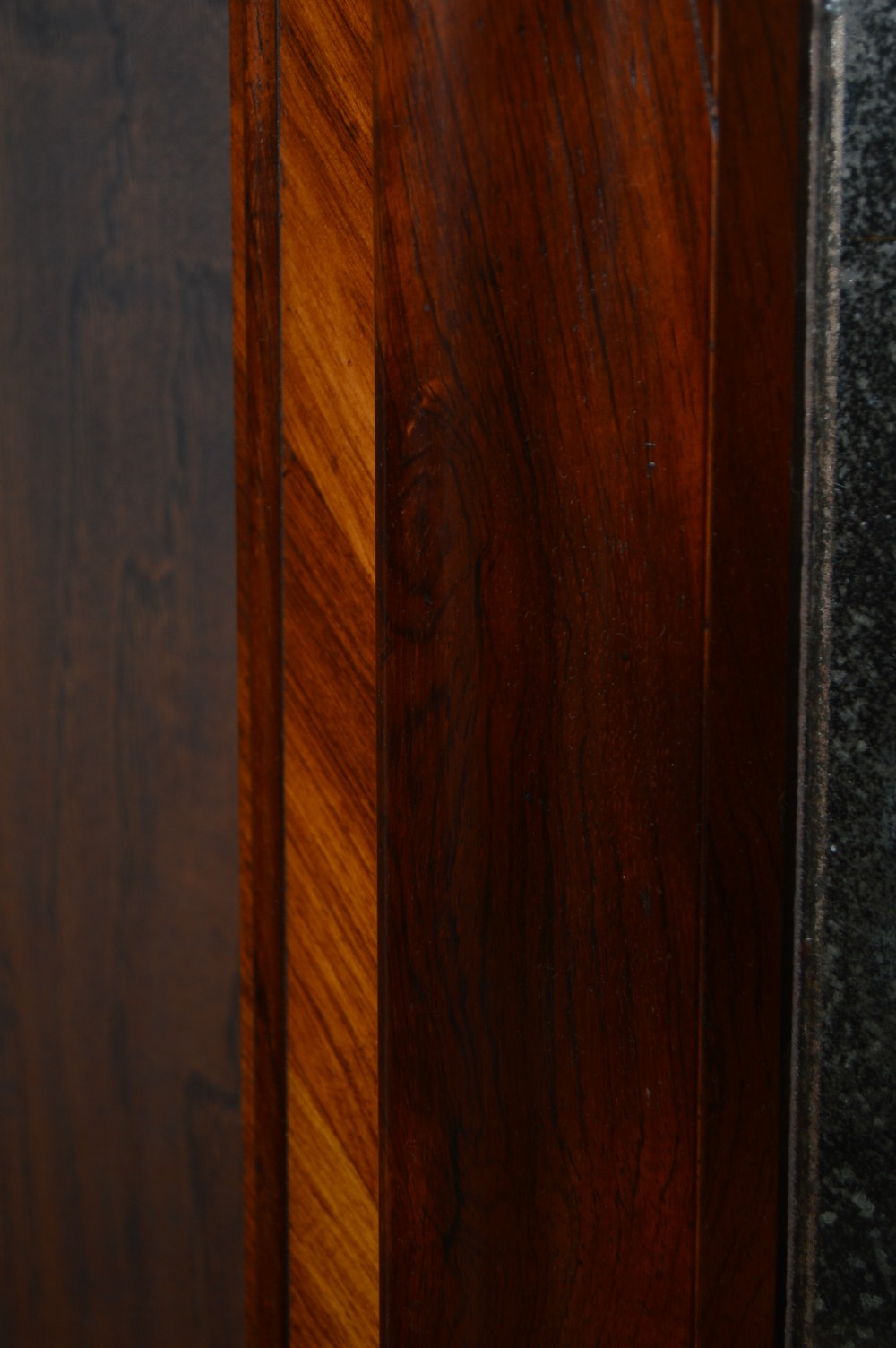 A rectangular antique wall mirror featuring a rich rosewood and kingwood crossbanded timber frame with distressed mirror glass. View V