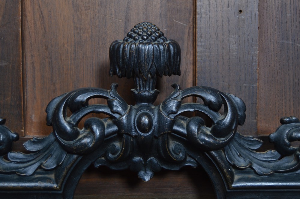 An ornate black Victorian cast iron stick stand featuring rope twist supports, central foliate scrollwork, and a drip tray at the base. View V