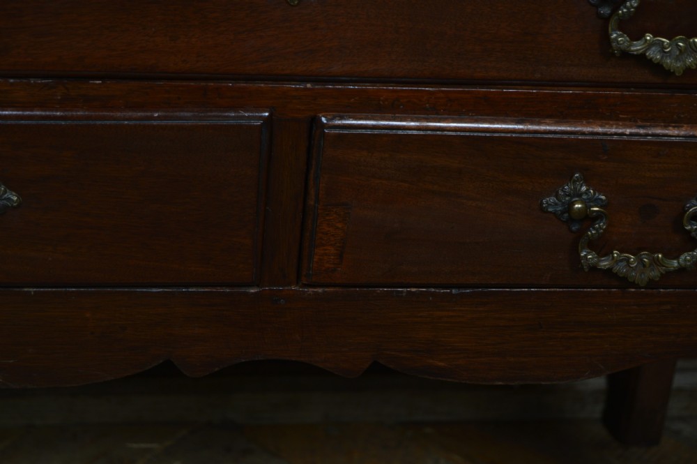 A dark mahogany Georgian lowboy table featuring one wide drawer above two smaller drawers with brass swan-neck handles. View X