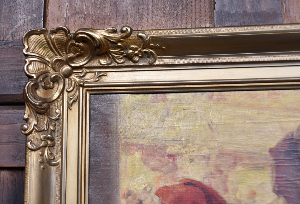 A framed oil painting depicting figures in carnival attire, including a pierrot and a jester, set within an ornate gilded frame. View IV