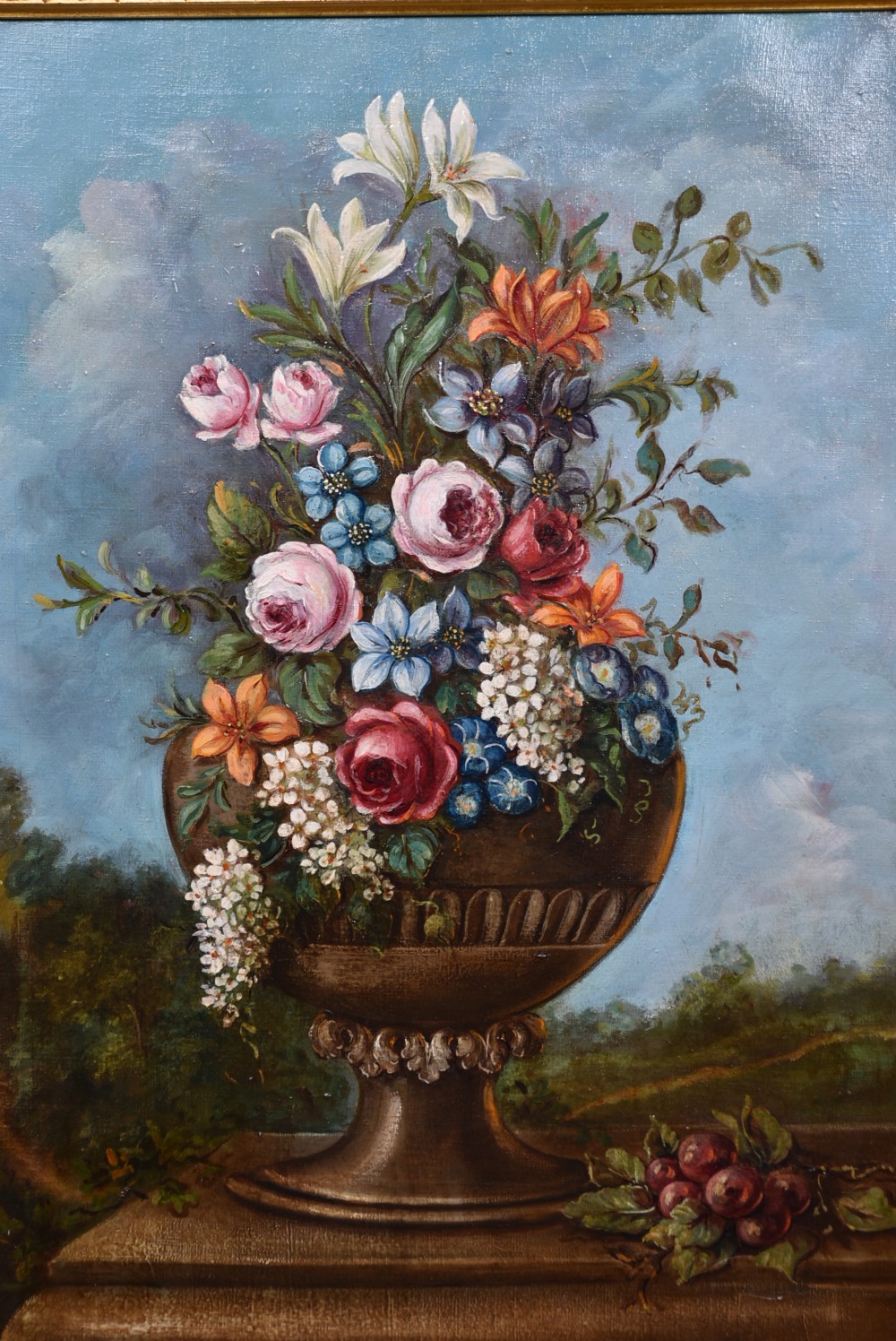 A framed oil painting depicting a floral arrangement in a classical urn resting on a stone pedestal against a blue sky. View III