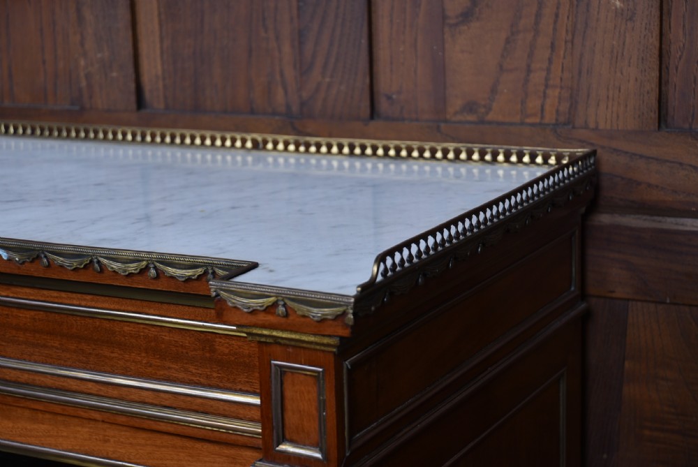 A French mahogany glazed bookcase featuring two glass-panelled doors, brass mounts, fluted side columns, and a light marble top. View III