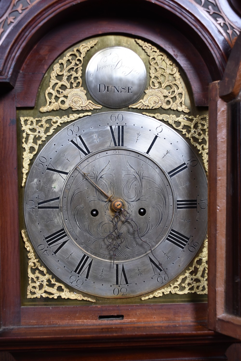 An antique Scottish mahogany longcase clock featuring a swan-neck pediment with an eagle finial and an engraved brass dial face. View VI