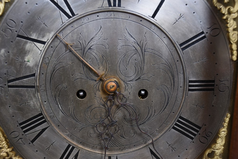 An antique Scottish mahogany longcase clock featuring a swan-neck pediment with an eagle finial and an engraved brass dial face. View X