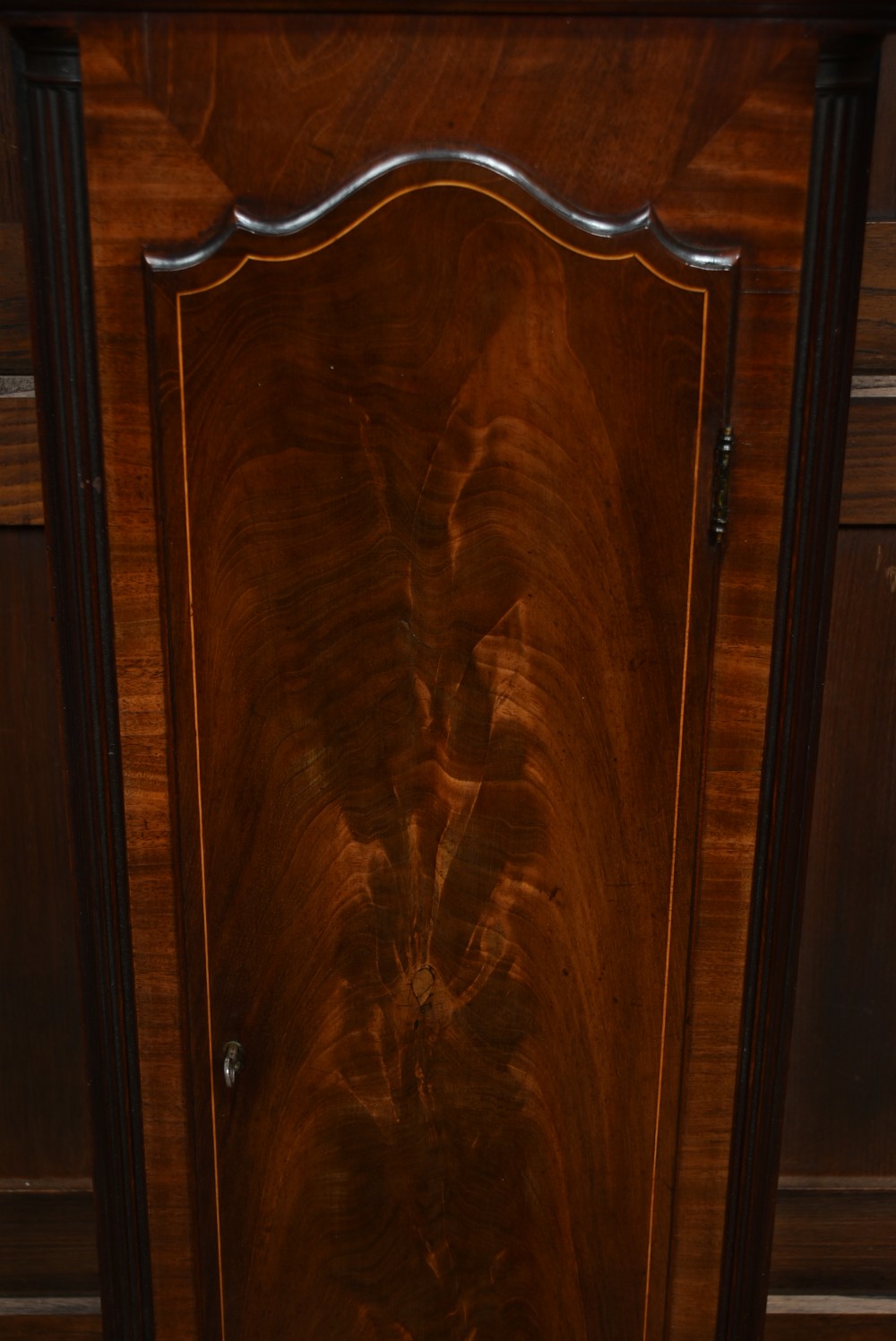 An antique Scottish mahogany longcase clock featuring a swan-neck pediment with an eagle finial and an engraved brass dial face. View XIV