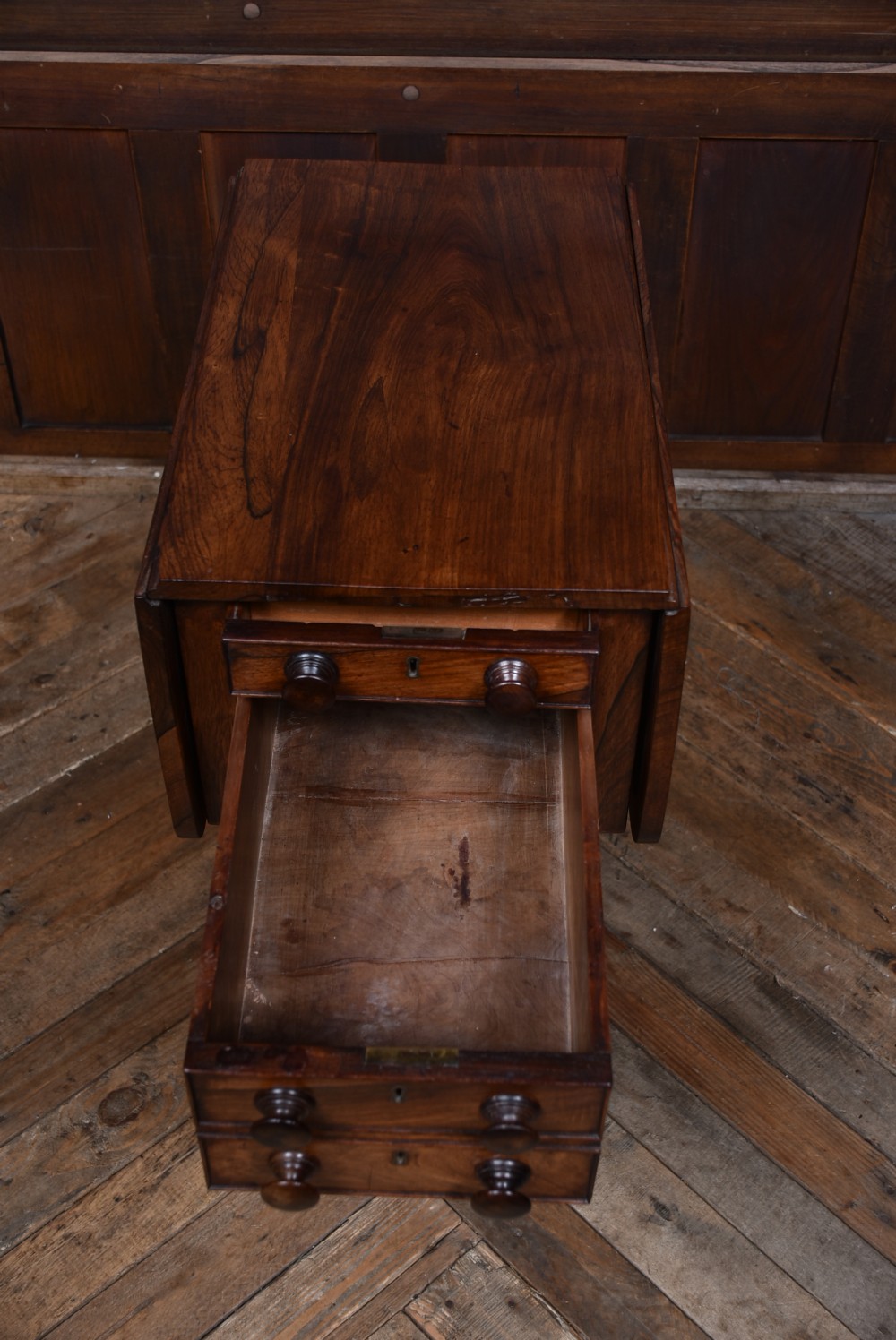 A Victorian rosewood drop-leaf work table featuring three drawers with turned wooden knobs and a central pedestal support on a shaped base. View XI