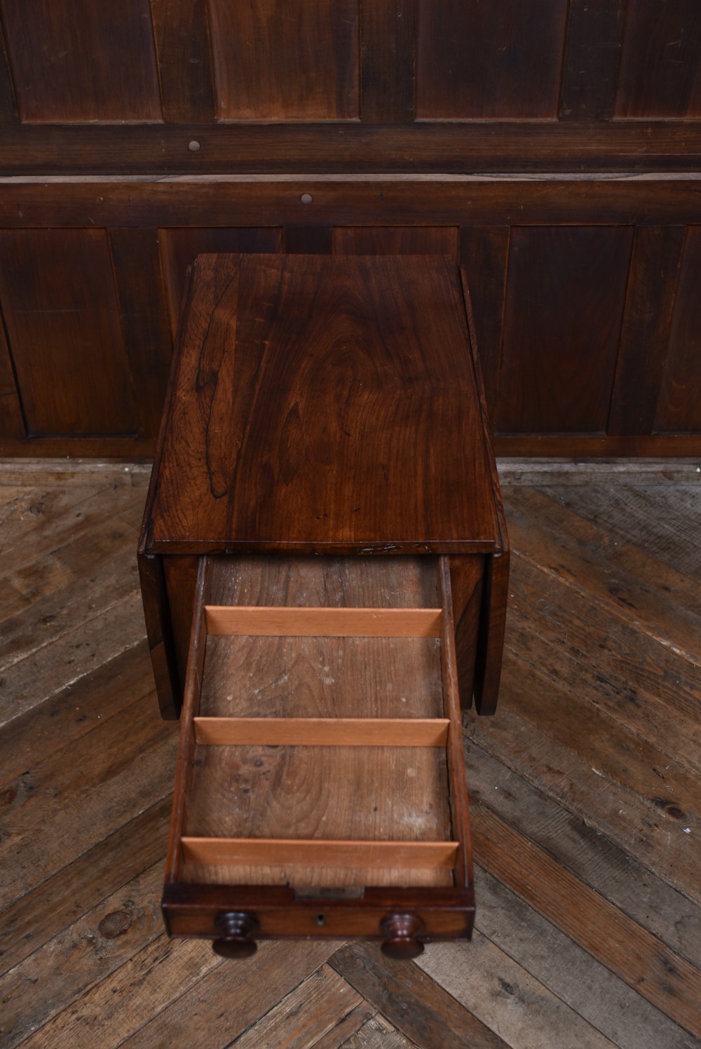 A Victorian rosewood drop-leaf work table featuring three drawers with turned wooden knobs and a central pedestal support on a shaped base. View XII