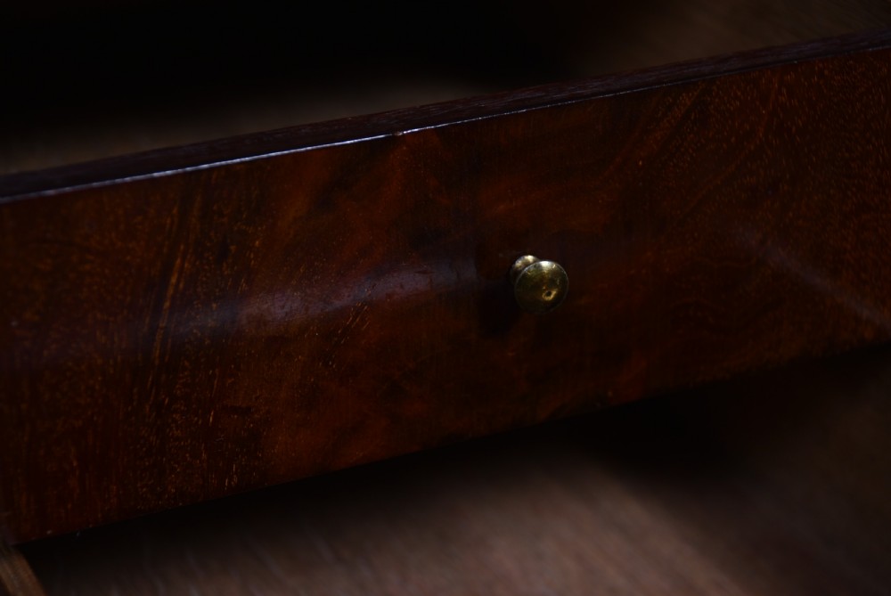 An antique walnut cylinder bureau featuring three full-width drawers with cast brass drop handles and keyhole escutcheons. View V