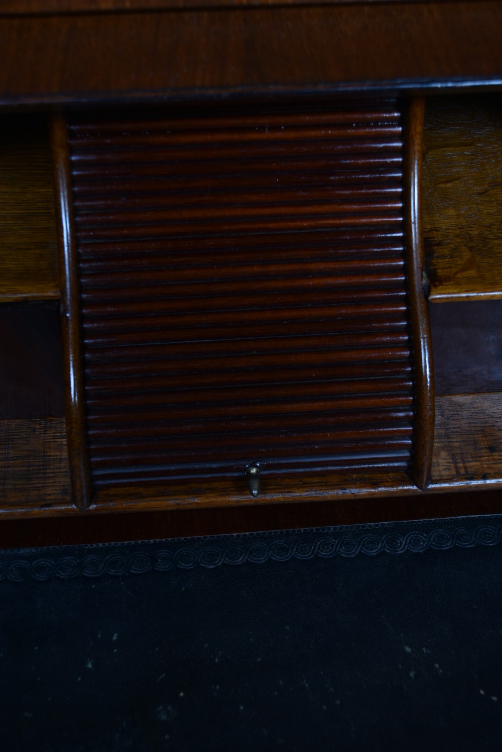 An antique walnut cylinder bureau featuring three full-width drawers with cast brass drop handles and keyhole escutcheons. View VI