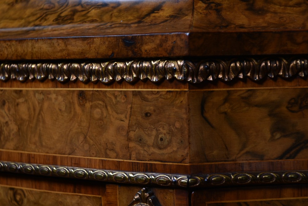 A Victorian burr walnut credenza featuring glazed doors, delicate marquetry inlay, and decorative gilt-metal mounts. View III