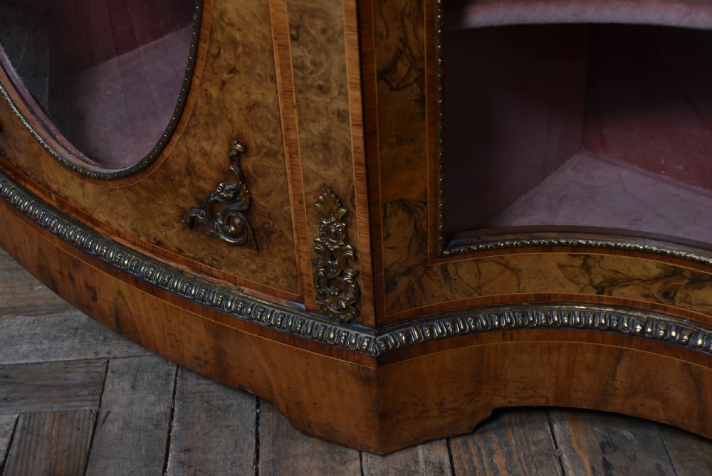 A Victorian burr walnut credenza featuring glazed doors, delicate marquetry inlay, and decorative gilt-metal mounts. View VI