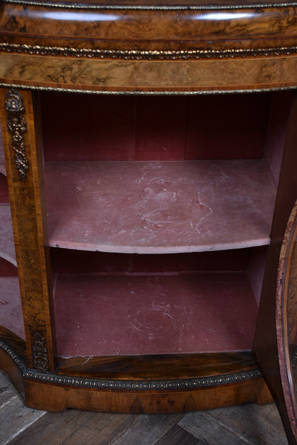 A Victorian burr walnut credenza featuring glazed doors, delicate marquetry inlay, and decorative gilt-metal mounts. View XI