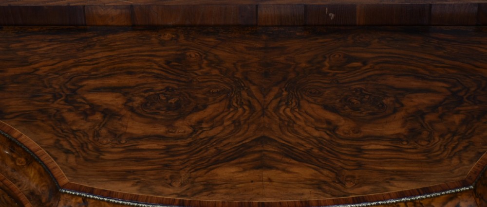 A Victorian burr walnut credenza featuring glazed doors, delicate marquetry inlay, and decorative gilt-metal mounts. View XXI