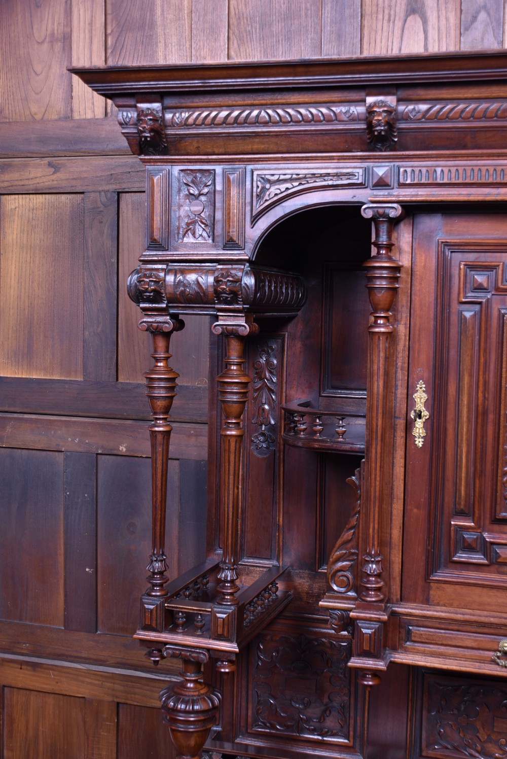 A pair of ornate dark walnut two-tier Continental cabinets featuring intricate carvings, turned columns, geometric panelled doors, and parquetry tops. View VII