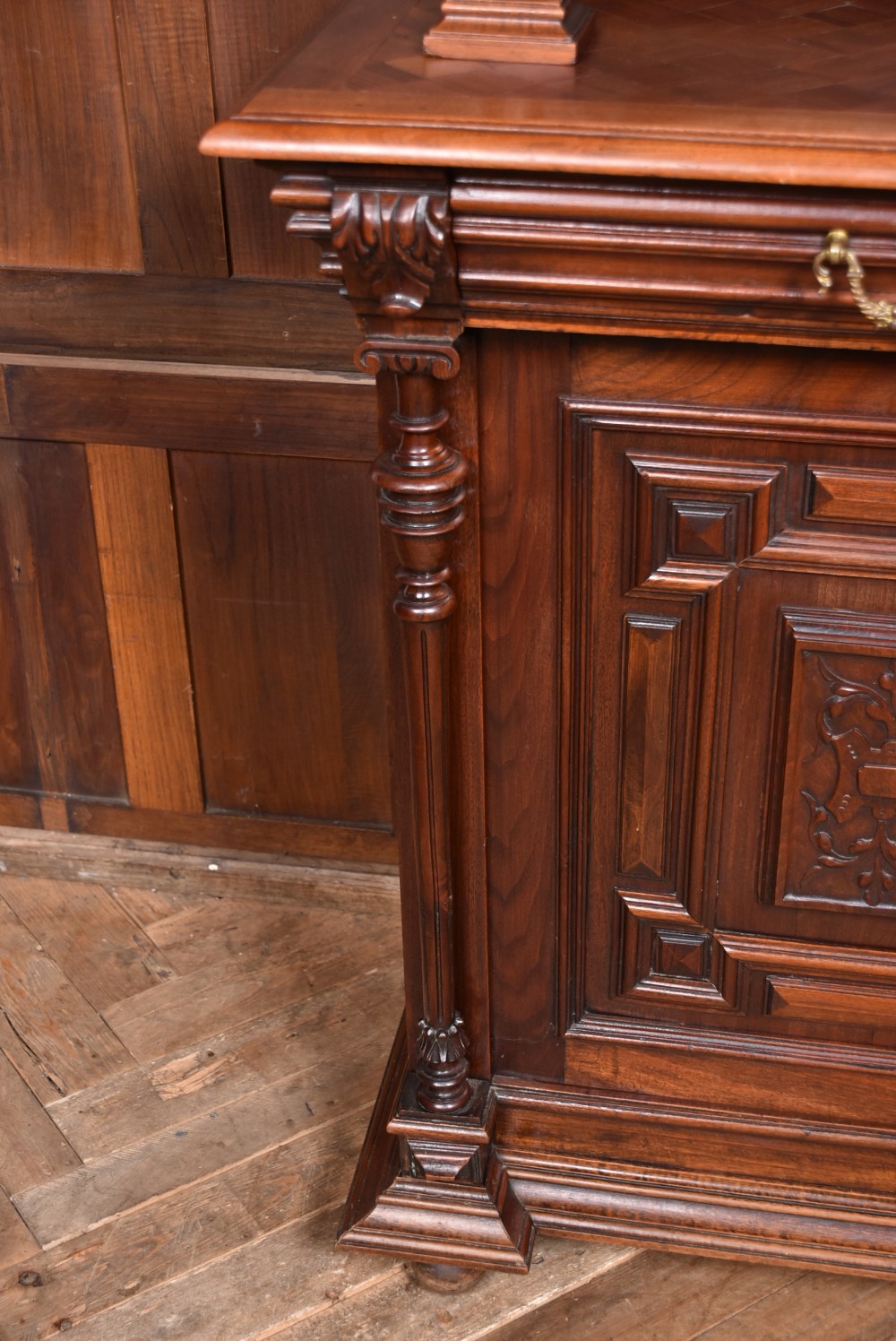 A pair of ornate dark walnut two-tier Continental cabinets featuring intricate carvings, turned columns, geometric panelled doors, and parquetry tops. View XIII